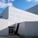 Contemporary industrial building showcasing geometric patterns and minimalist design in Compiègne, France.